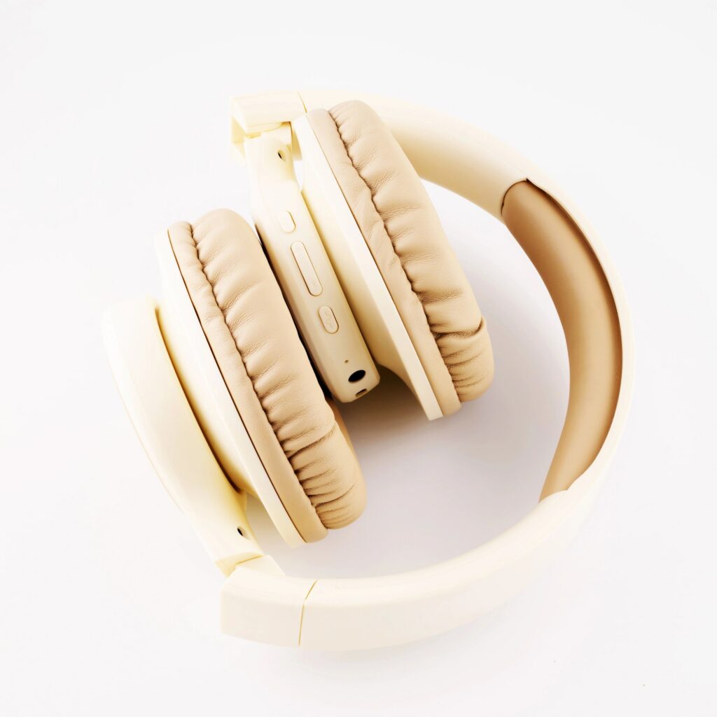 folded wireless headphones in beige color close up