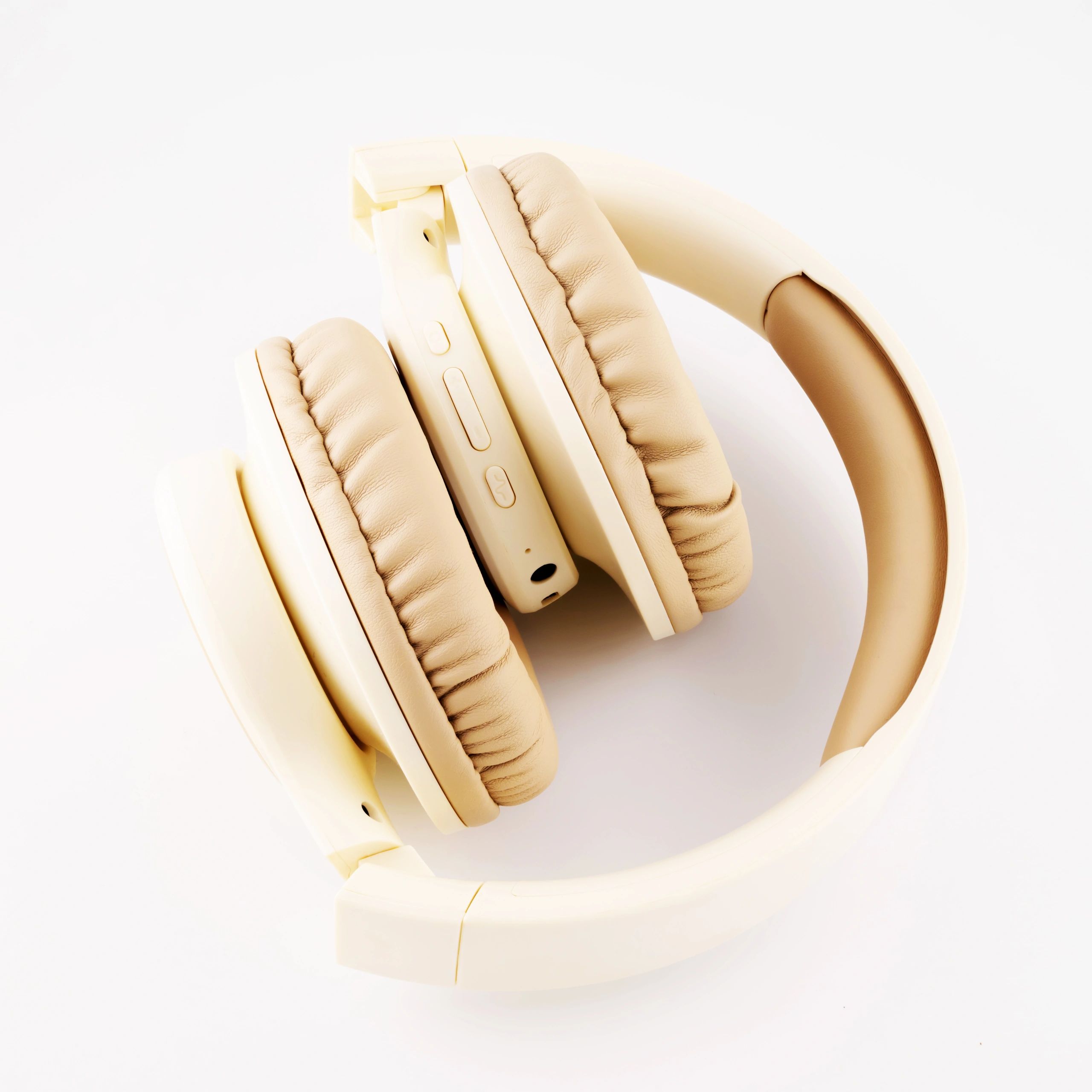 folded wireless headphones in beige color close up